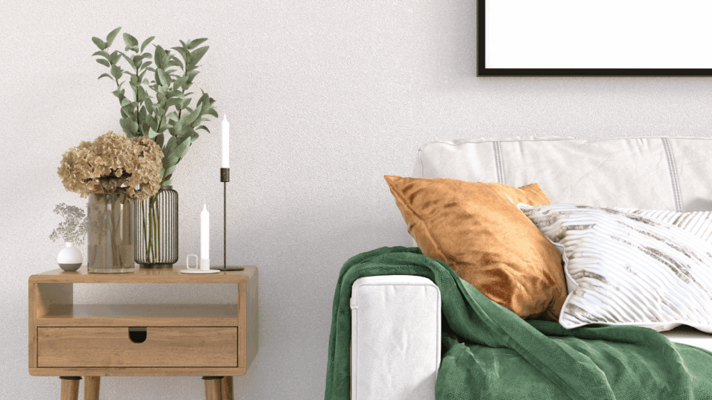 Calm and tidy living room corner with a cozy couch and throw blanket — setting the tone for a grounded Sunday reset.