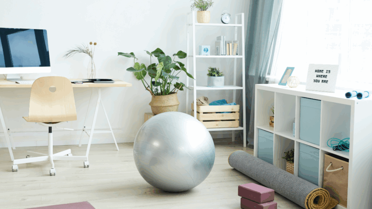 Home workout setup with yoga mat, yoga blocks, and a desk in a bright home office, representing a simple work-from-home exercise routine.